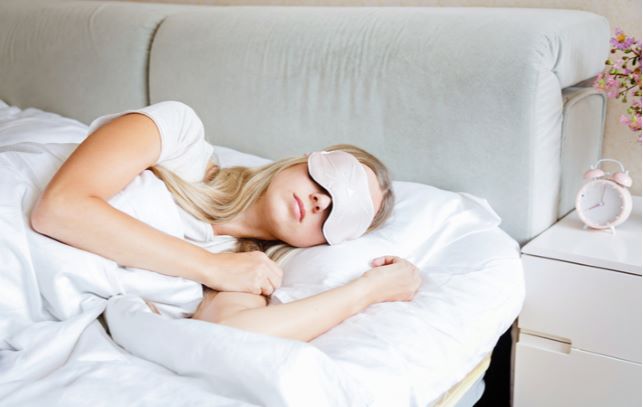 Young women wearing eye mask while sleeping for relief of dry eyes