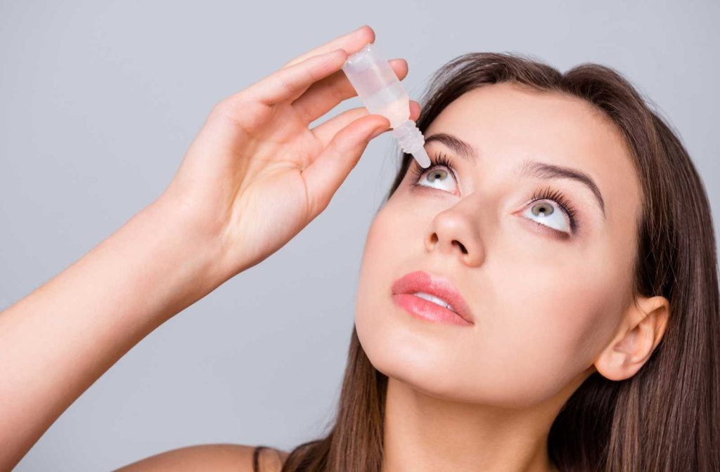 Women applying atropine eye drops to help with myopia