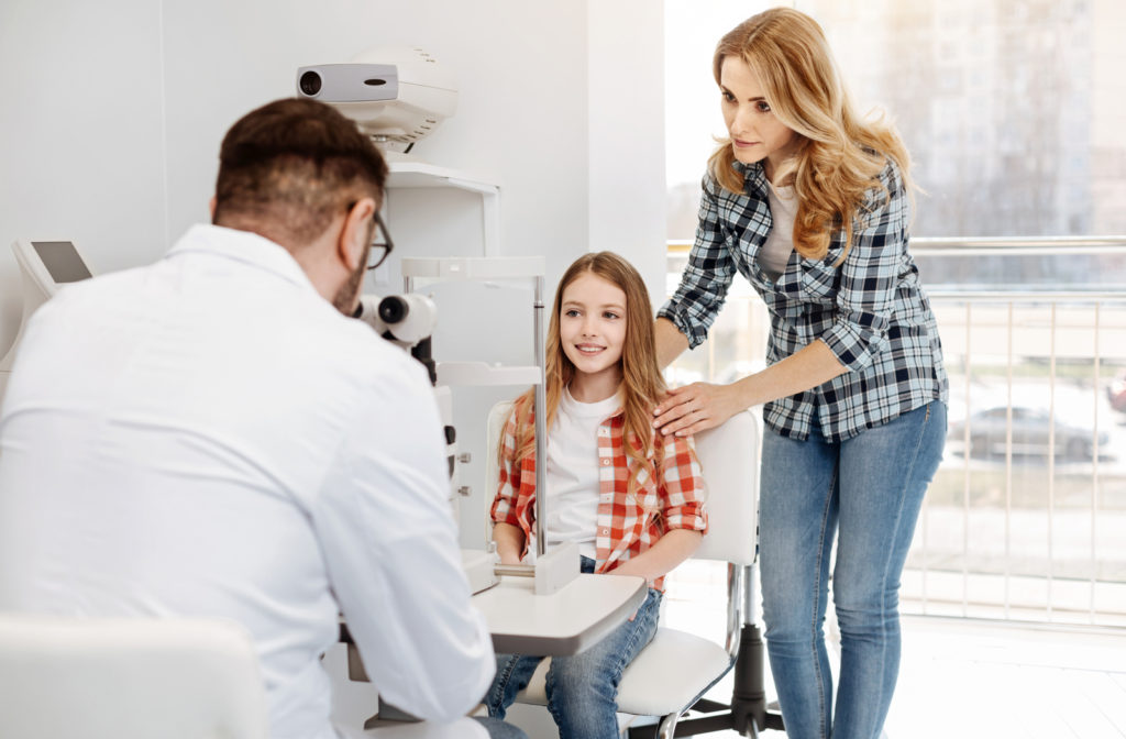 Mother accompanying her daughter for vision therapy with optometrist