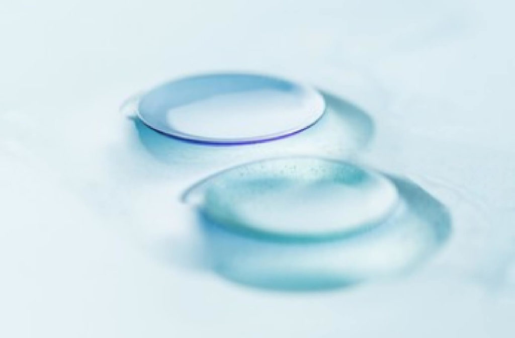 A pair of Rigid gas-permeable (RGP) lenses. Made of harder plastics than soft contact lenses, they are oxygen-permeable, allowing air to pass through and allowing your eyes to "breathe."