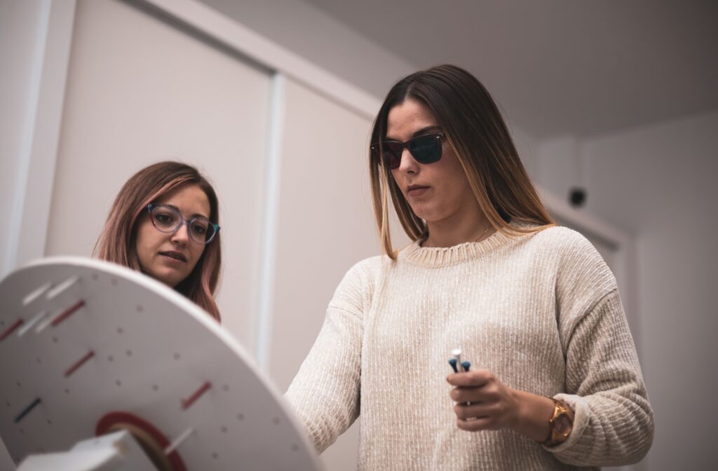 A young adult in vision therapy focusing on an exercise.